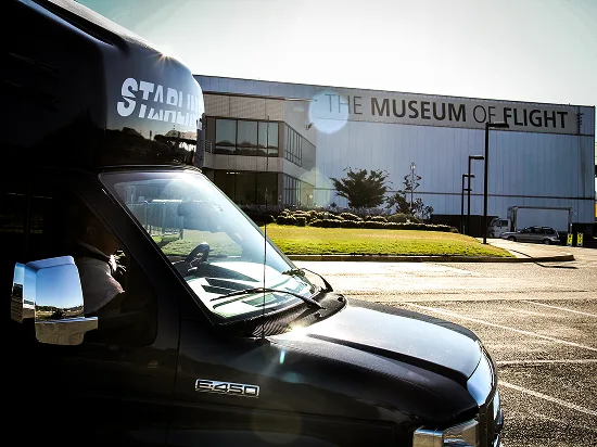 Starline Collection luxury charter bus parked outside The Museum of Flight in Seattle