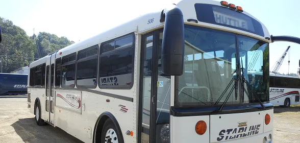 Starline Collection white shuttle bus parked in fleet yard, ideal for corporate and event transportation