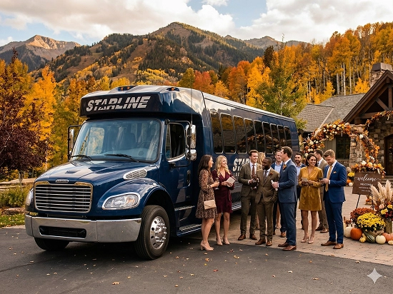Wedding guests gathered beside a Starline mini coach outside a mountain venue surrounded by autumn foliage