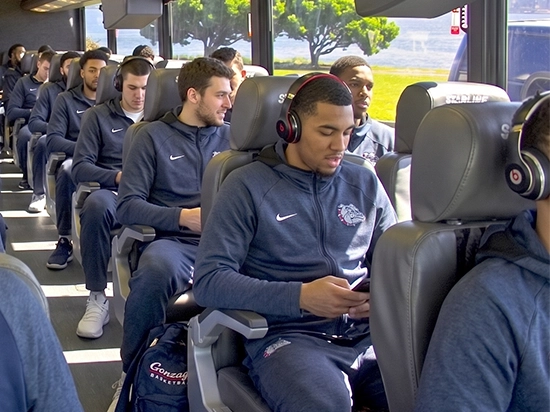 Gonzaga Basketball team members seated comfortably aboard a luxury charter bus during team travel