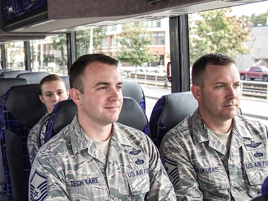US Air Force service members seated comfortably aboard a Starline charter bus