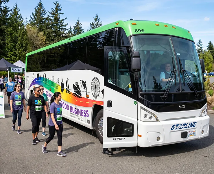 Starline charter bus at a 5K event in the Pacific Northwest with participants walking alongside