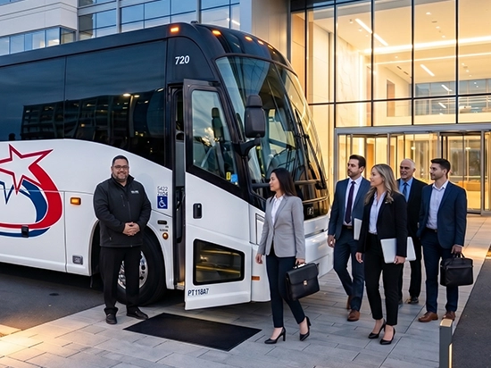 Professional Starline Collection driver welcoming corporate executives boarding a luxury charter bus outside a modern office building