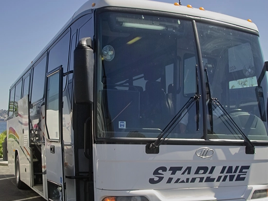 Starline Collection luxury charter bus exterior front view on a clear sunny day