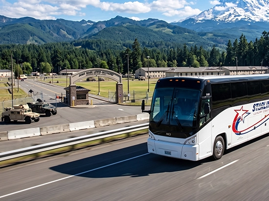 Starline luxury charter bus traveling past Joint Base Lewis-McChord with Mount Rainier in background