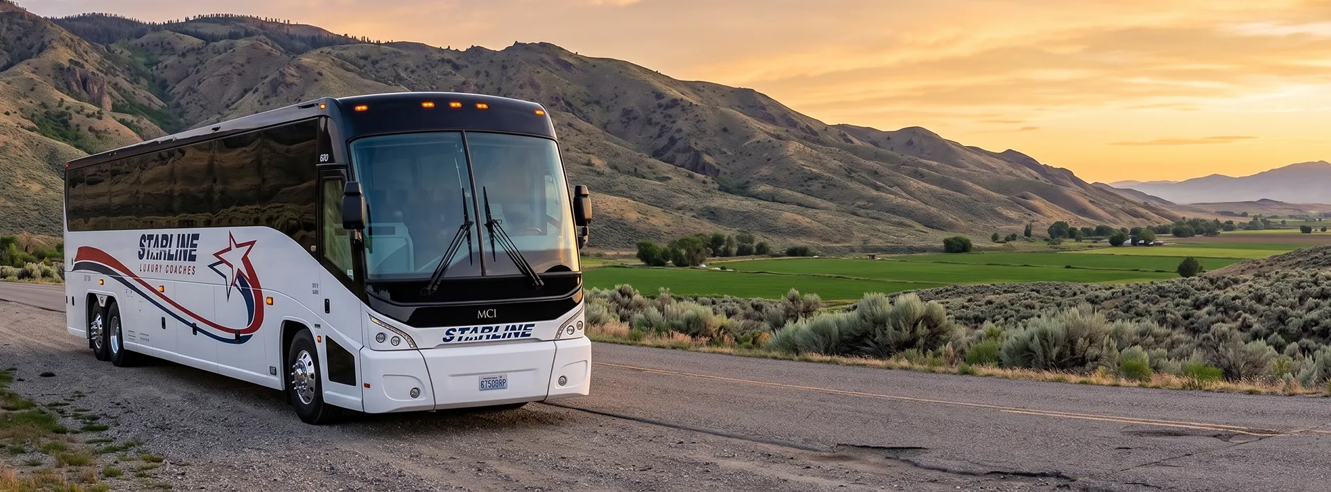 Starline Luxury Coaches MCI charter bus parked on a rural road with rolling hills and farmland at sunset